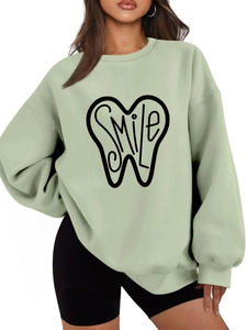 Detail of the smile tooth print on mint green oversized warm fleece sweatshirt for women