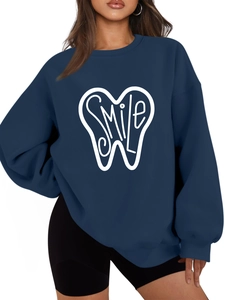 Close-up of the white smile teeth print on a navy blue oversized thick sweatshirt