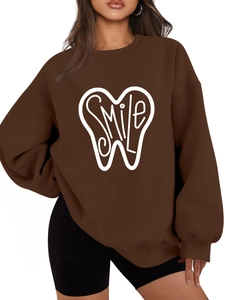 Detail of oversized dark brown fleece sweatshirt featuring white SMILE teeth art print