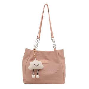 Pink canvas tote bag with chain strap and cute cloud charm on white background