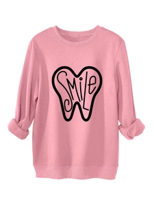 Detailed view of the pink sweatshirt ribbed cuffs and smile graphic print on fabric