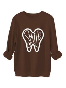 Detail of SMILE graphic print on a thick dark brown long-sleeve crewneck sweatshirt