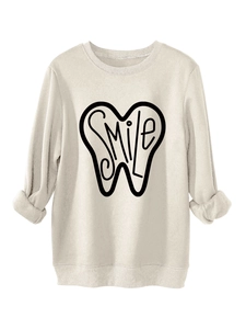 Detail of SMILE tooth graphic print on cozy off-white thick fleece sweatshirt for women