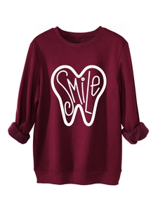 Close-up of the fleece lining and white smile tooth print on burgundy sweatshirt