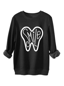 Detail of black fleece-lined sweatshirt showing smile tooth print and thick fabric texture
