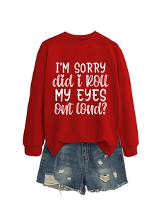 Detail of red sweatshirt with artistic white text print paired with denim shorts