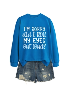 Detail of royal blue sweatshirt with white slogan print and distressed denim shorts