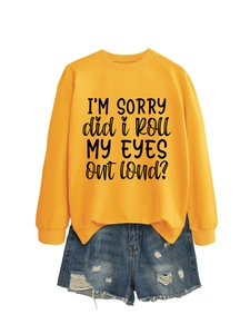 Close-up of bright yellow sweatshirt with 'I'm sorry' text and distressed denim shorts