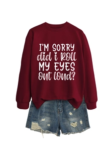 Flat lay of burgundy sweatshirt with white slogan and distressed blue denim shorts