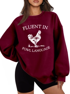 Detail of burgundy oversized sweatshirt with fowl language print and ribbed cuffs