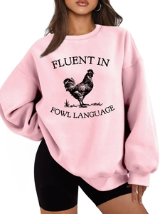 Close-up of pink sweatshirt featuring a black rooster print and fluent in fowl text