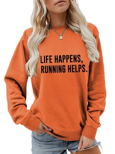 Detail of the Life Happens Running Helps slogan printed on orange crewneck sweatshirt