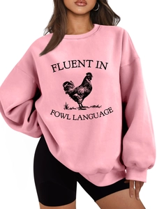 Close-up of pink oversized sweatshirt with Fluent in Fowl Language rooster print