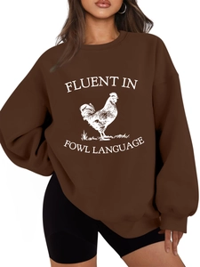 Detail of dark brown sweatshirt featuring white fluent in fowl language rooster print