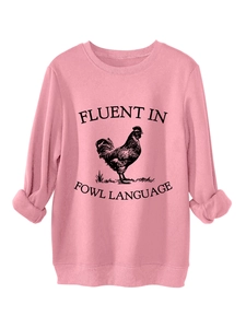 Detail of pink sweatshirt featuring fluent in fowl language print and rooster graphic