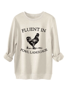 Close-up of ribbed cuffs and fluent in fowl language print on beige sweatshirt