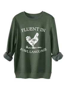 Close-up of thick green sweatshirt showing warm gray fleece lining and fowl language print