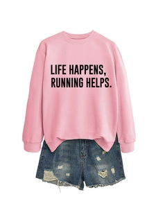 Flat lay of pink sweatshirt with Life Happens Running Helps text and denim shorts