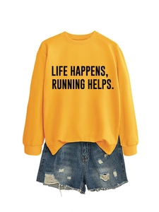 Detail of ginger yellow sweatshirt with Life Happens Running Helps text and denim shorts