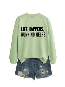 Flat lay of light green Life Happens Running slogan sweatshirt and blue denim shorts