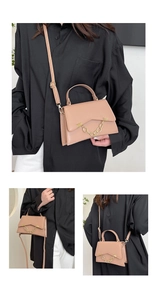 Detail view of pinkish beige crossbody bag with gold chain decoration and top handle