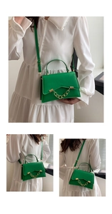 Close-up of green crossbody bag featuring a stylish gold chain decoration and top handle