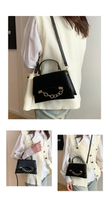 Close-up of black crossbody bag featuring a decorative gold chain and leather texture