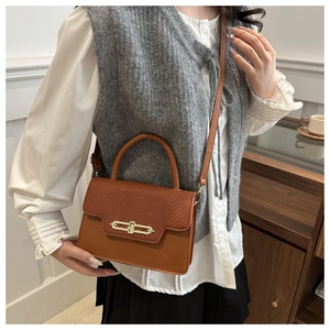 Brown vintage structured handbag with animal skin texture and gold metal lock detail