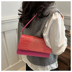 Detail of rose pink crocodile pattern underarm bag with gold metal buckle and strap
