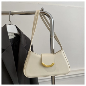 Detail of a creamy white leather shoulder bag featuring a sleek golden arc metal buckle