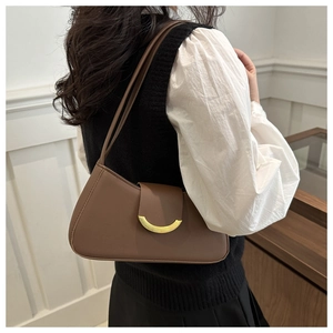 Detail of a brown vintage shoulder bag with a gold crescent buckle and smooth leather