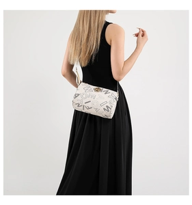 Detail of white cylinder bag featuring black letter prints and a golden round buckle