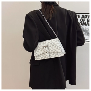 Close-up of white leather crossbody bag with gray M-letter print and chain strap