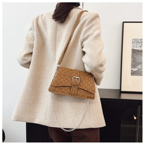 Brown monogram crossbody bag with silver buckle and chain on beige blazer outfit