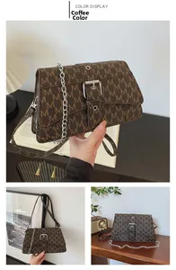 Detail of coffee brown crossbody bag with letter M pattern and metal buckle decoration