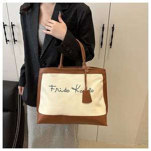 Detail of vintage tote bag in canvas and brown leather with Frido Kalo text