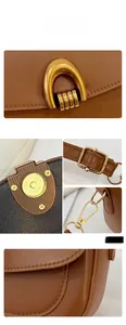 Close-up of golden U-shaped buckle and magnetic closure on a brown leather saddle bag