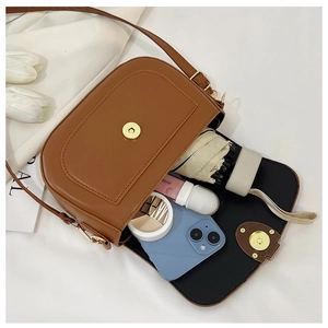 Top view of brown saddle bag showing interior space for phone and umbrella
