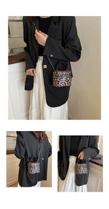 Detail of leopard print bucket bag featuring silver hardware and black chain strap