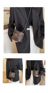 Detail of leopard print cylinder bag with silver metal chain and double zipper closure