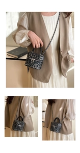 Detail of leopard print cylinder bag with silver zipper and chain strap