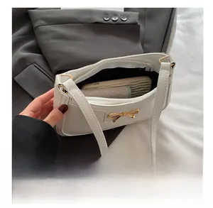 Internal view of white crescent bag showing storage capacity for phone and wallet