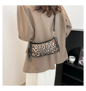 Close-up of leopard print shoulder bag with black strap and elegant gold hardware