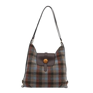 Vintage plaid wool backpack with brown leather trim and antique metal buckle closure