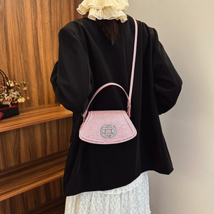 Pink sequin crossbody bag with crystal buckle shown on a model in a fashion scene