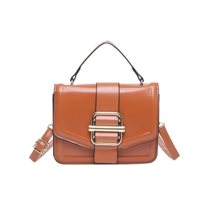 Brown faux leather crossbody bag with top handle and gold buckle detail on white background