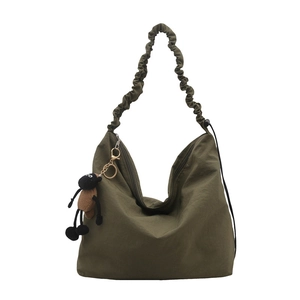 Dark green hobo tote bag with pleated shoulder strap and plush sheep pendant charm