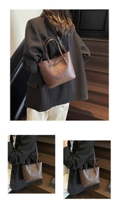 Detail showing vintage brown tote bag with metal buckles and textured faux leather finish