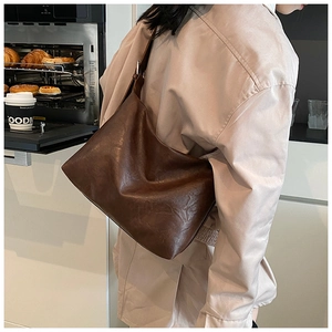 Close-up of vintage brown tote bag with premium leather texture and soft sheen finish