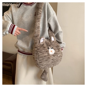 Detail of plush cat crossbody bag showing fuzzy texture, soft ears, and long strap